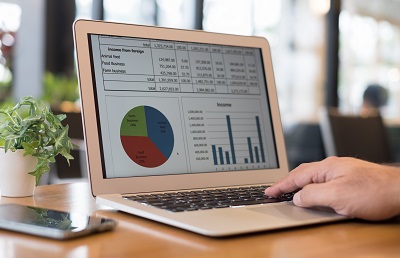 laptop in office displaying finance report